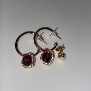 2 gold paired heart earrings.